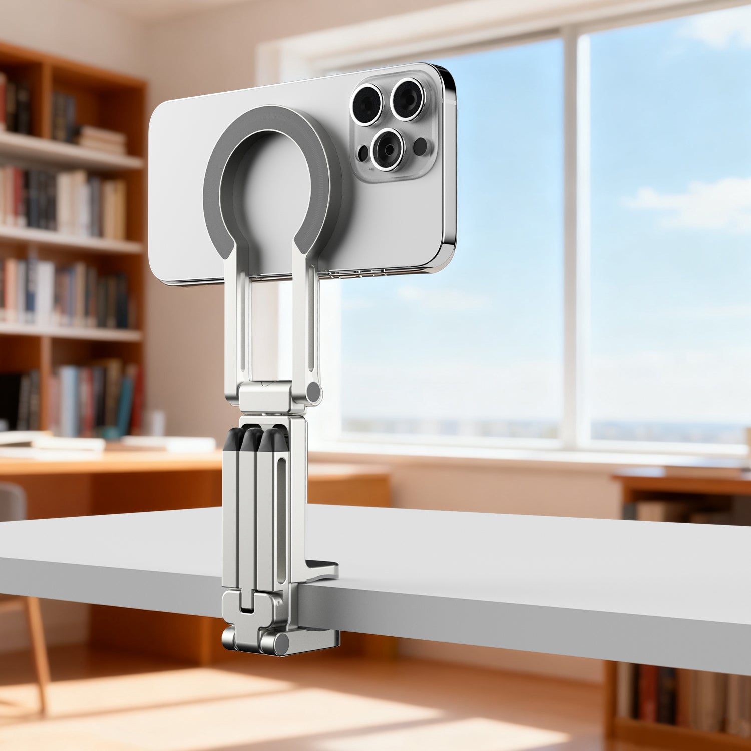 MagSafe clamp tripod attached to a desk, holding an iPhone.